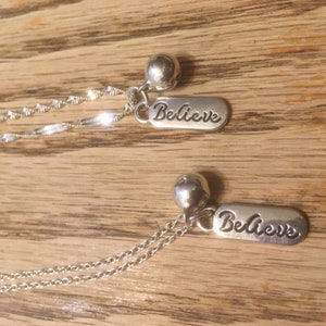 Silver BELIEVE pendant necklace with tinkling bell