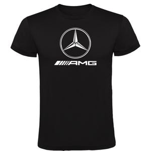 May include: Black t-shirt with a white AMG logo. The logo features a three-pointed star inside a circle, with the AMG text underneath. The t-shirt has a crew neck.