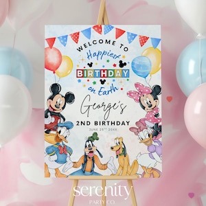 May include: A wooden easel displays a colorful birthday sign with Disney characters. The sign reads "Welcome to Happiest Birthday on Earth" and features Mickey and Minnie Mouse, Donald Duck, Goofy, and Pluto. Pastel balloons in pink, blue, and white surround the easel.
