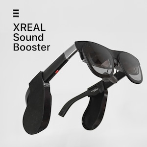 Op de afbeelding: Zwarte XREAL Sound Booster-bril met donkere glazen. De bril heeft een strak, modern design met een zilverkleurig accent op de pootjes. De tekst "XREAL Sound Booster" staat in het wit linksboven.