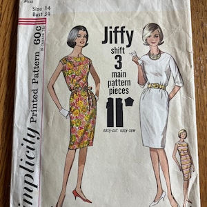 May include: A vintage Simplicity 4947 sewing pattern envelope for a Jiffy shift dress in size 14 with a 34-inch bust. The cover features illustrations of three dress variations, including a floral print, a solid white dress, and a striped design.