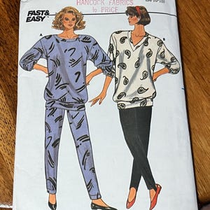 May include: Butterick 3990 sewing pattern envelope for sizes 14-16-18. The front shows two illustrations: a blue top and pants set with black abstract markings, and a white top with black paisley prints paired with solid black leggings.