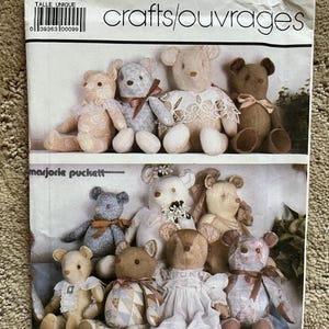 May include: A white ceramic mug with a black handle and the text "But First, Coffee" in a black, bold font. The mug is on a white surface.