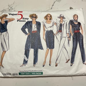May include: A vintage Vogue sewing pattern packet featuring illustrations of five easy-to-sew women's outfits. The packet includes the text "Vogue 5 Easy Pieces" and "Very Easy / Très Facile". The pattern number is 2315.