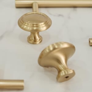 May include: A set of three ceramic mugs with a speckled, matte finish. The mugs are in shades of cream, light gray, and dark gray. Each mug has a simple, minimalist design, perfect for coffee or tea.