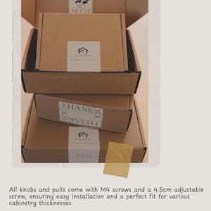 May include: A white ceramic mug with a black handle and the text "But First, Coffee" in a black, bold font. The mug is on a white surface. The mug is approximately 10 cm tall.