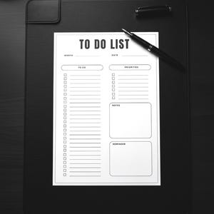 May include: A black and white to-do list notepad with a pen on a black desk mat. The notepad has sections for to-do items, priorities, notes, and reminders. The text "TO DO LIST" is at the top.