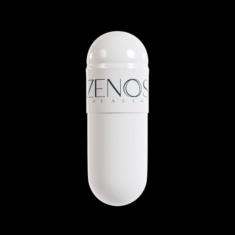 May include: A white capsule with a rounded top and a cylindrical body. The capsule has a band with the text "ZENOS HEALTH" in a dark blue font. The background is solid black.