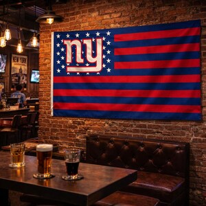 May include: A flag with a blue field of stars and red and blue stripes. The flag features the letters "NY" in white with a red outline. The flag is hanging on a brick wall in a bar setting.