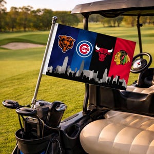May include: A golf cart displaying a flag with the logos of the Chicago Bears, Chicago Cubs, Chicago Bulls, and Chicago Blackhawks. The flag includes a skyline silhouette. The cart is on a golf course.