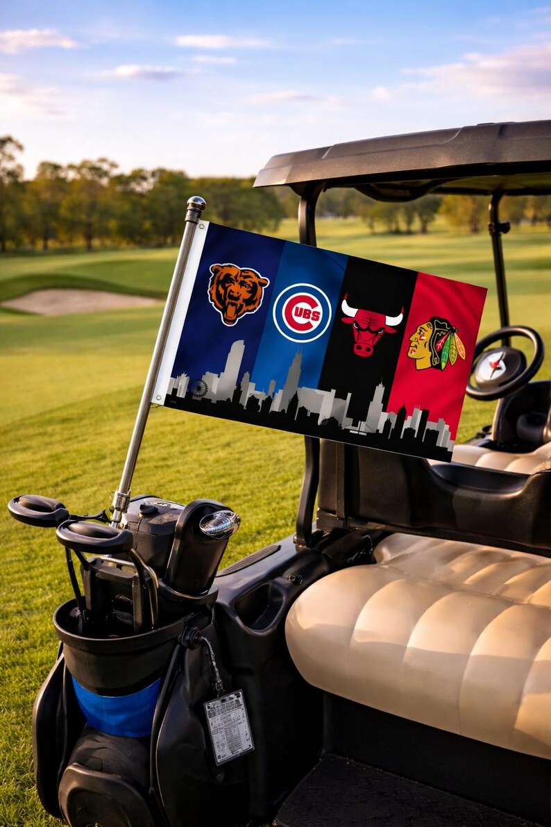 May include: A golf cart displaying a flag with the logos of the Chicago Bears, Chicago Cubs, Chicago Bulls, and Chicago Blackhawks. The flag includes a skyline silhouette. The cart is on a golf course.