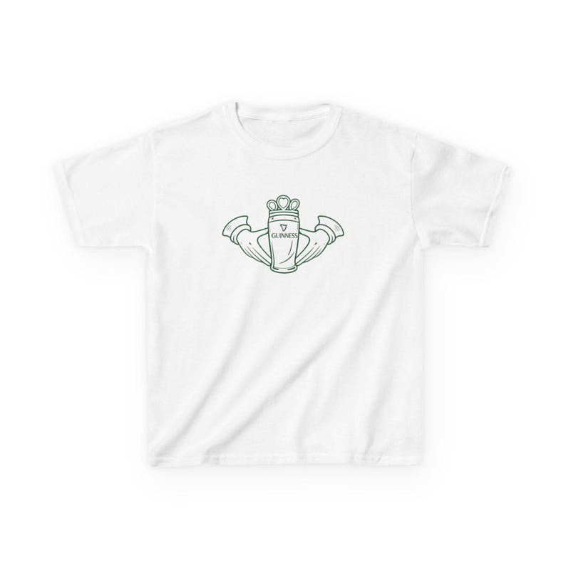 May include: White t-shirt with a green outline of a Claddagh design, incorporating a Guinness pint glass. The Claddagh symbol, with a heart, crown, and hands, is centered. The word "Guinness" is printed on the pint glass.