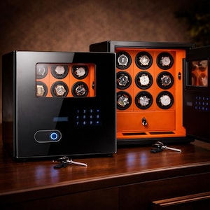 May include: Black watch winder with a glass door displaying several watches. The interior is orange, with individual compartments for each watch. A digital keypad and a blue power button are visible on the front. Two keys are on the wooden surface.