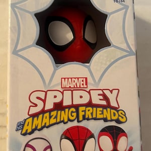 May include: A Marvel Spidey and His Amazing Friends toy figure in a box. The box features the Spidey character's head peeking out of a web design. The box also displays the characters Spidey, Ghost-Spider, and Miles Morales. The box is marked for ages 3+.