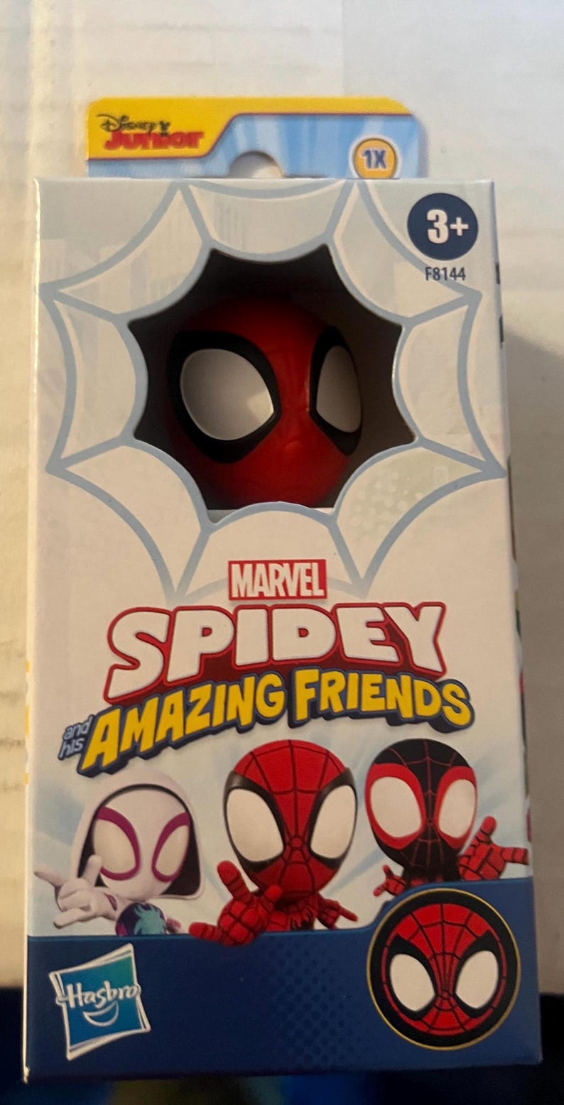 May include: A Marvel Spidey and His Amazing Friends toy figure in a box. The box features the Spidey character's head peeking out of a web design. The box also displays the characters Spidey, Ghost-Spider, and Miles Morales. The box is marked for ages 3+.