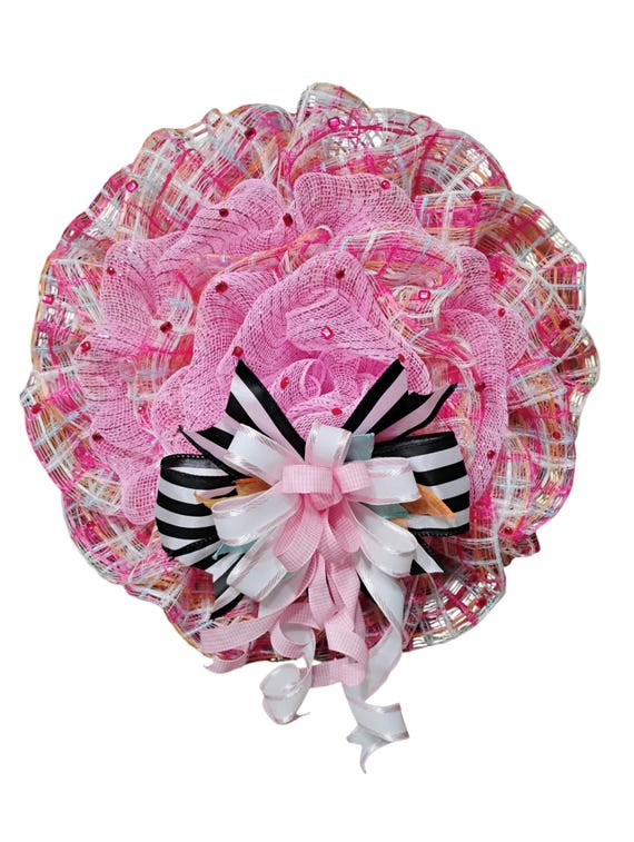 Door wreath in pink and pastel plaid with black and white ribbon accent