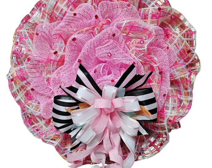 Door wreath in pink and pastel plaid with black and white ribbon accent