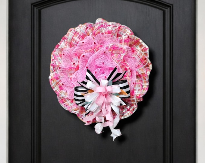 Door wreath in pink and pastel plaid with black and white ribbon accent
