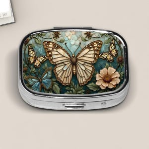 Butterfly Garden Pill Box – Stained Glass Style Floral Travel Pill Case – Nature-Inspired Pocket Organizer for Women