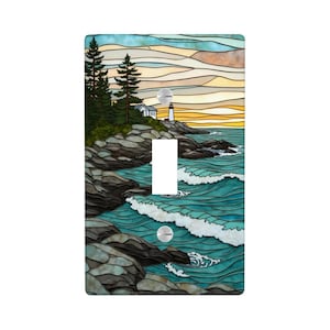 May include: A decorative light switch cover featuring a coastal scene. The design includes a lighthouse, ocean waves, and a colorful sky. The artwork is in a stained-glass style, with a single toggle switch opening and a round outlet opening.
