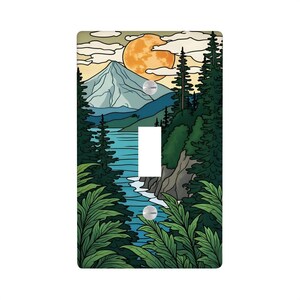 May include: A decorative light switch cover featuring a scenic landscape. The design includes a mountain, lake, and forest under a large orange moon. The cover is rectangular with a single toggle switch opening and two screw holes.