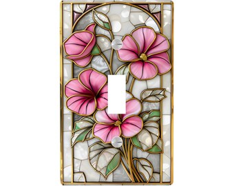 May include: A decorative light switch cover featuring a floral design. Pink flowers with gold accents and green leaves are set against a white background with a gold border. The switch plate has a single toggle opening.