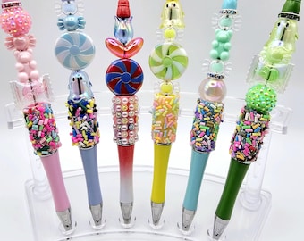 Bolígrafo divertido con cuentas y diseño de caramelos inspirado en Bling. Viene con recambio.