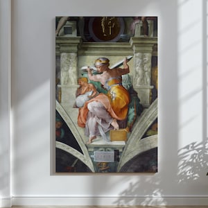 May include: A large framed print of a Renaissance-era fresco. The artwork depicts several figures in vibrant colors, including orange, yellow, and purple, set against a backdrop of architectural details. The figures are engaged in a dramatic scene.