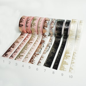 May include: Ten rolls of washi tape with different patterns and colors. The tape has a gold foil design with a dripping effect. The tape is numbered 1 through 10.