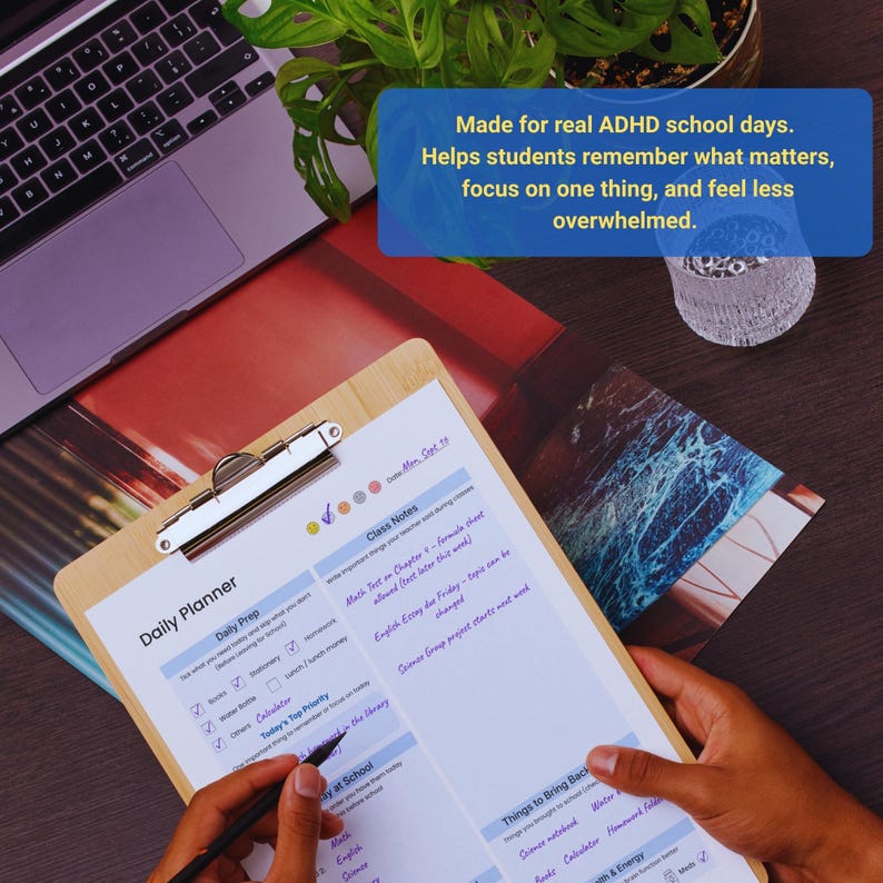 May include: A wooden clipboard with a daily planner sheet, featuring checkboxes and sections for notes and priorities. The text on the sheet includes "Daily Prep" and "Class Notes." A laptop and a plant are in the background. Text on the image says "Made for real ADHD school days."