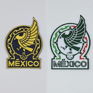 May include: Two embroidered patches featuring the Mexico national soccer team emblem. The left patch is navy blue and yellow, while the right patch is white, green, and red. Both display an eagle, a soccer ball, and the text MEXICO at the base.