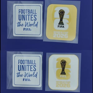 May include: Four square stickers in clear protective sleeves. Two stickers are white with blue text reading FOOTBALL UNITES the World FIFA. Two stickers are yellow and white with the FIFA World Cup 2026 trophy graphic and text.