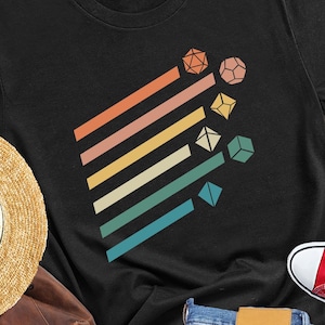 May include: A black t-shirt with a retro dice graphic, straw hat, brown backpack, blue jeans, and red sneakers. The shirt has the text "Rustic United". The sneakers are red with white laces.