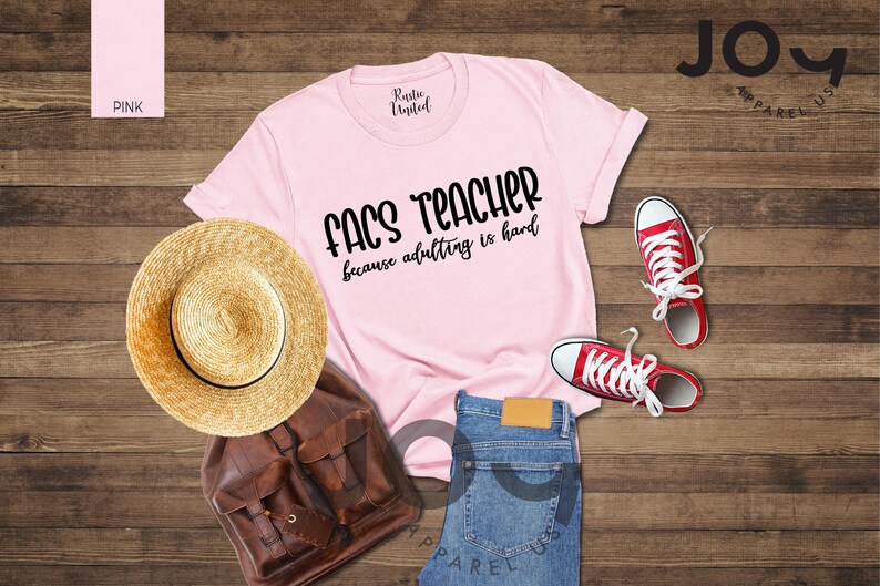 May include: A light pink t-shirt with the text "FACS TEACHER because adulting is hard" in black. The image also includes a straw hat, brown backpack, blue jeans, and red sneakers.