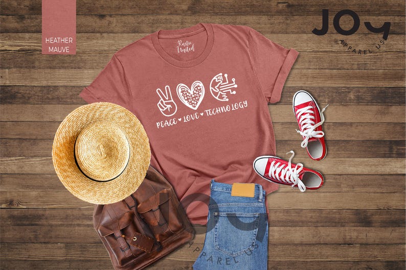 May include: A heather mauve t-shirt with the words "Peace, Love, Technology" in white. The image includes a straw hat, brown backpack, blue jeans, and red sneakers. The items are arranged on a wooden surface.