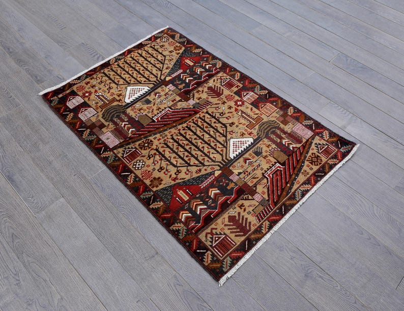 Pu&ograve; includere: Un tappeto tradizionale con un motivo geometrico in tonalit&agrave; di rosso, marrone e beige. Il tappeto presenta un motivo ripetitivo di alberi e case stilizzate.