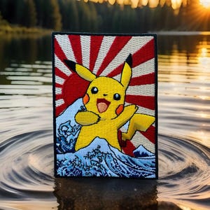 May include: An embroidered patch featuring Pikachu, a popular Pokemon character, standing on a wave with a red and white rising sun in the background.