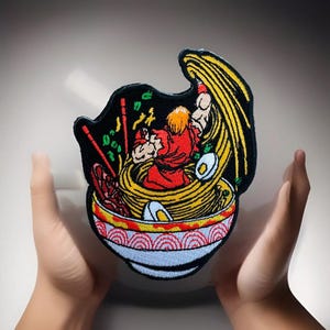 May include: Embroidered patch featuring a cartoon character in a red outfit, throwing noodles from a bowl. The bowl is decorated with a red and yellow pattern. The character is surrounded by noodles and other ingredients.