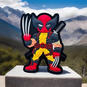 May include: A red and yellow cartoon character with black claws and a red mask. The character is wearing a yellow belt with a red skull and crossbones. The character is standing on a gray surface.