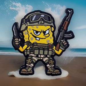 May include: An embroidered patch featuring a yellow, porous character wearing a tactical helmet with goggles, a green vest, and camouflage pants. The character holds a black knife in one hand and a brown and black rifle in the other hand.