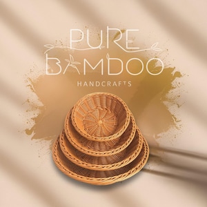 May include: Four woven bamboo baskets of varying sizes are stacked together. The baskets are a light brown color and have a circular shape. The image includes the text "PURE BAMBOO HANDCRAFTS" in white.