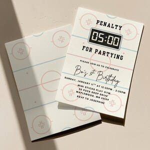 May include: Hockey-themed birthday party invitations. The design features a hockey rink graphic with pink and blue lines and circles. The invitation text includes "PENALTY 05:00 FOR PARTYING" and details for the party, including the birthday boy's name and age.
