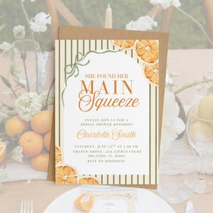 May include: A bridal shower invitation with the text "SHE FOUND HER MAIN SQUEEZE". The design features vertical green stripes, dried orange slices, and a brown envelope. The invitation includes details for Charlotte Smith's bridal shower.
