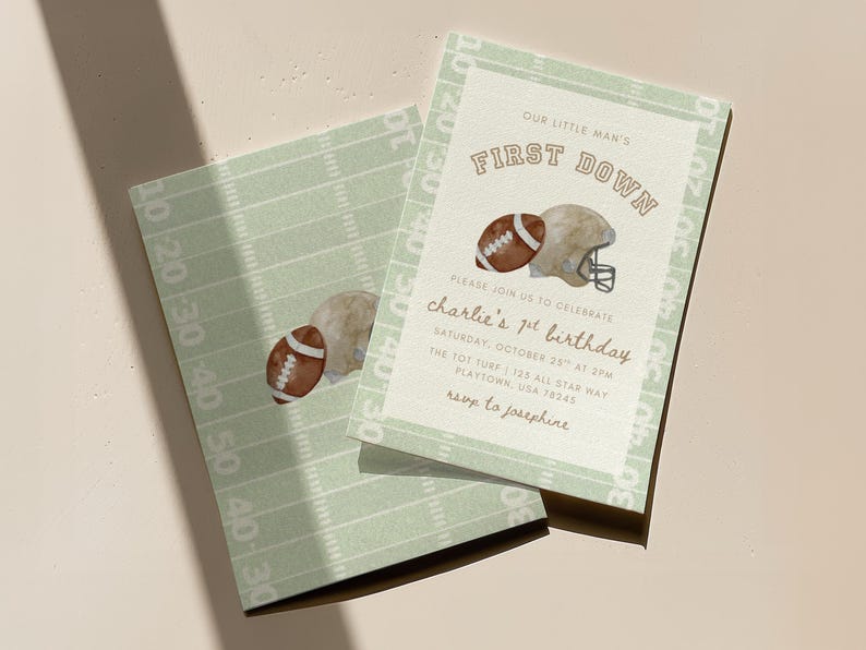 May include: Two light green football-themed invitations. One features a football and helmet graphic with the text "FIRST DOWN" and "charlie's 1st birthday". The other has a football graphic and field lines.