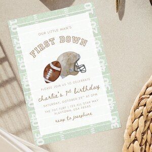 May include: A football-themed invitation card. It features a watercolour illustration of a football and helmet, with the text "FIRST DOWN". The invitation is for a first birthday party, with details included.