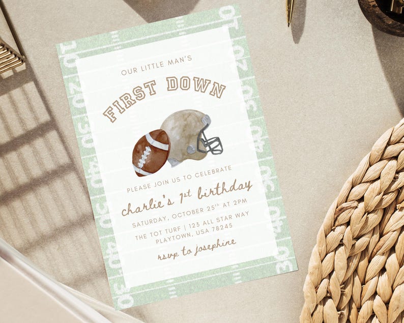 May include: A football-themed invitation card. It features a watercolour illustration of a football and helmet, with the text "FIRST DOWN". The invitation is for a first birthday party, with details included.