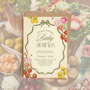May include: A baby shower invitation with a vintage design. The invitation features the text "Locally Grown Baby On The Way" in elegant script. Floral and fruit illustrations, including lemons and tomatoes, adorn the edges.
