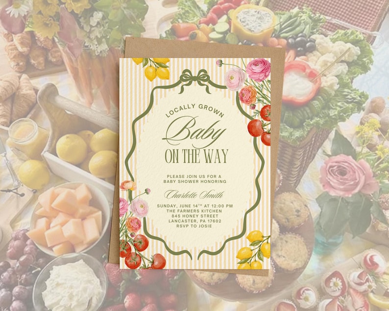 May include: A baby shower invitation with a vintage design. The invitation features the text "Locally Grown Baby On The Way" in elegant script. Floral and fruit illustrations, including lemons and tomatoes, adorn the edges.