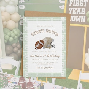 May include: A football-themed invitation card with a brown envelope. The card features a football and helmet illustration, with the text "OUR LITTLE MAN'S FIRST DOWN" and details for a first birthday celebration.