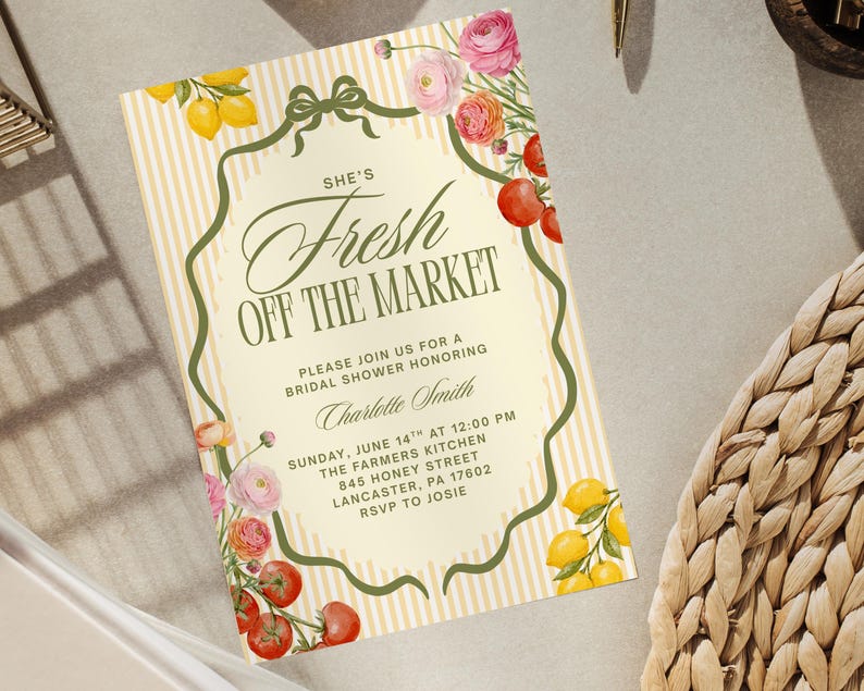 May include: A bridal shower invitation with a vintage design. The invitation features the text "She's Fresh Off The Market" in elegant script, surrounded by floral and fruit illustrations. The background has vertical stripes.